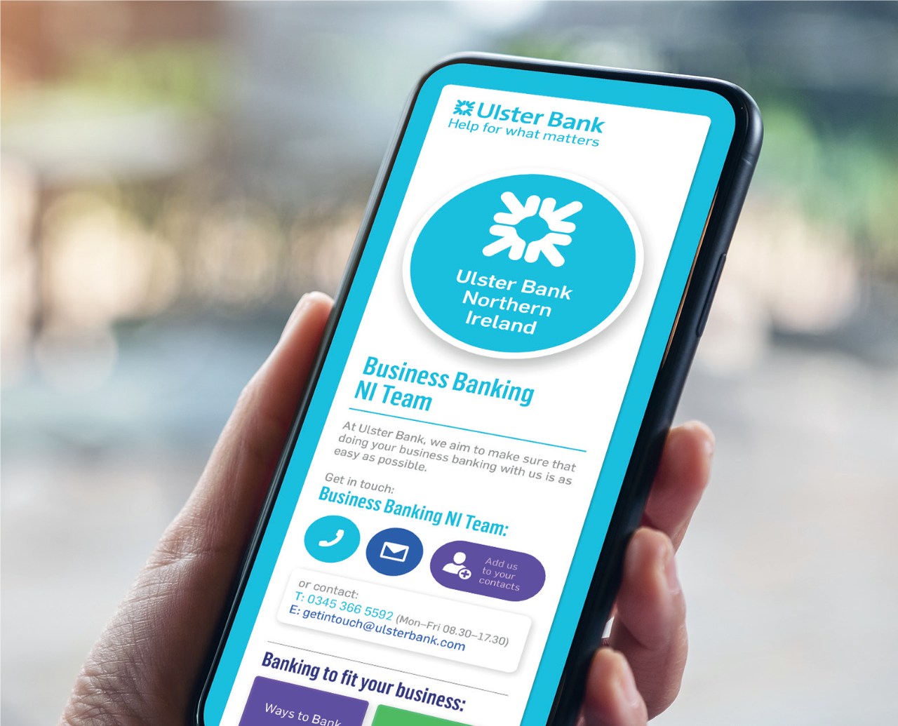 Ulster Bank app page displaying on smartphone being held up.