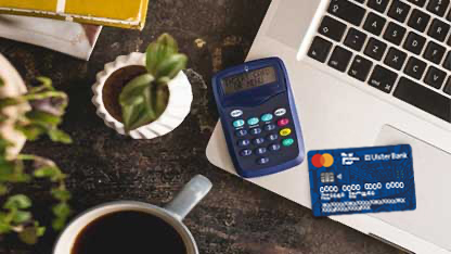 Checking payments with a calculator and debit card detail.