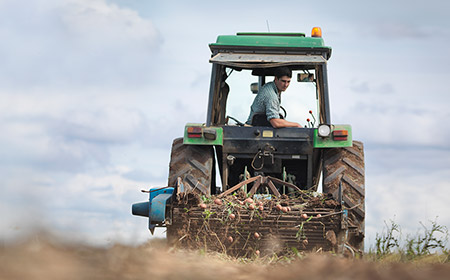 A farmer driving a tractor