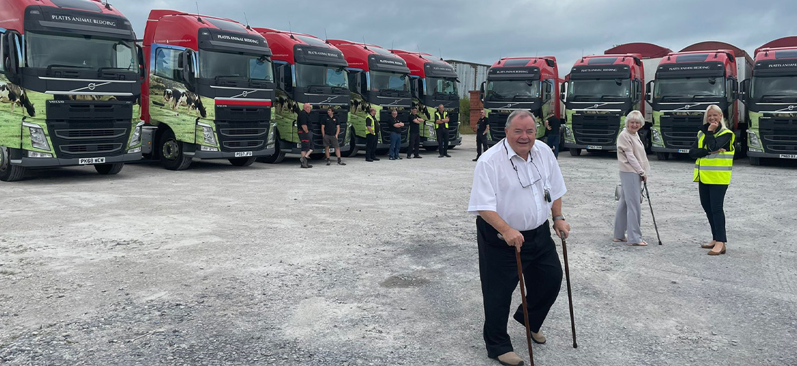 photo of the family in front of yard of trucks