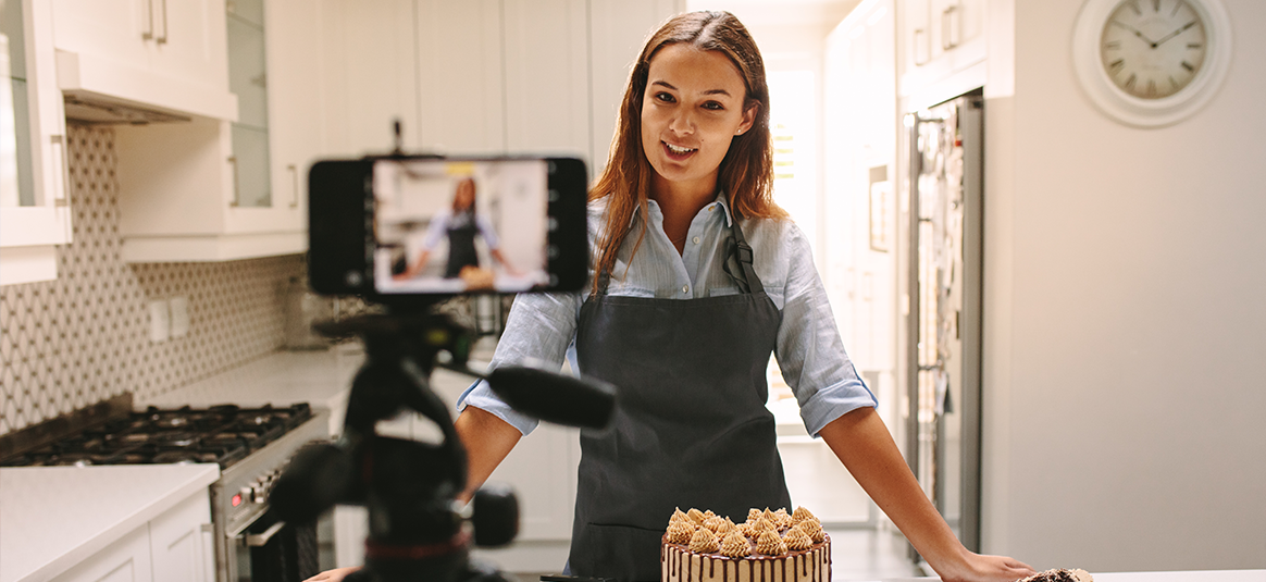 A baker filming herself on a phone