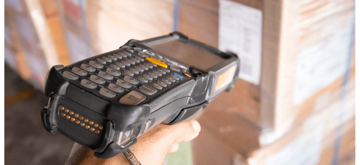 Close up of a worker's hand holding a barcode scanner