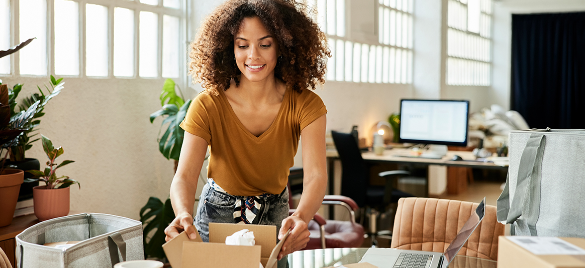 photo of a woman opening a box on a table