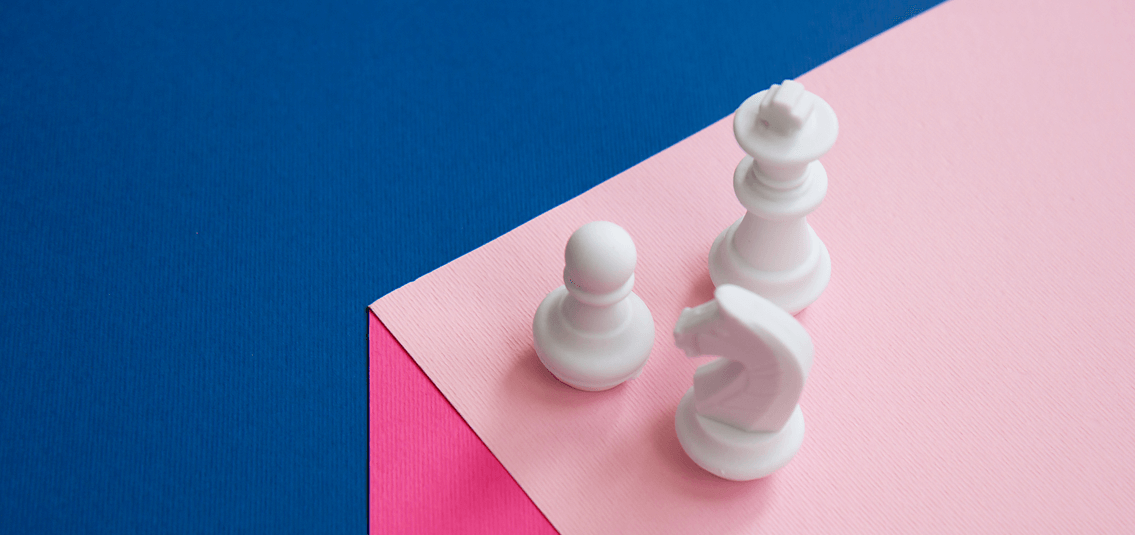 White chess pieces on a cube