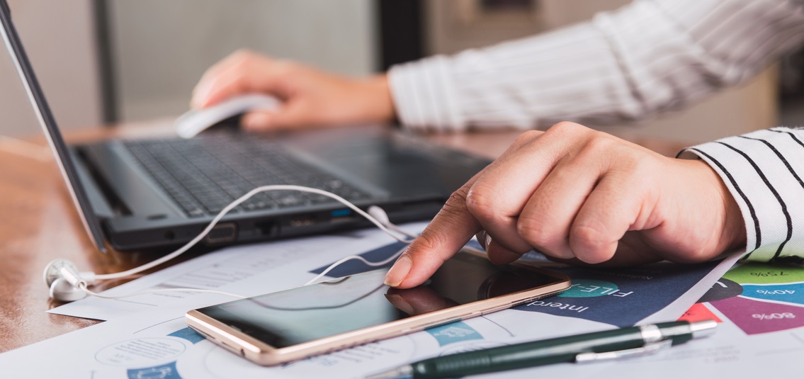 person using laptop and phone