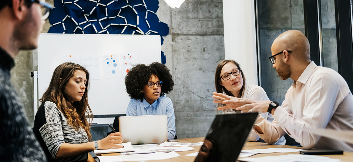 Photo of people around a table having a meeting