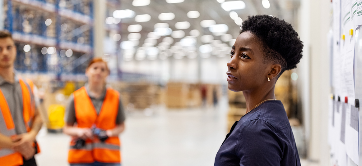 Three workers in a warehouse 