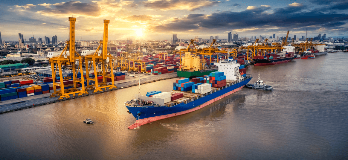 Freighter ship docked in large port with containers