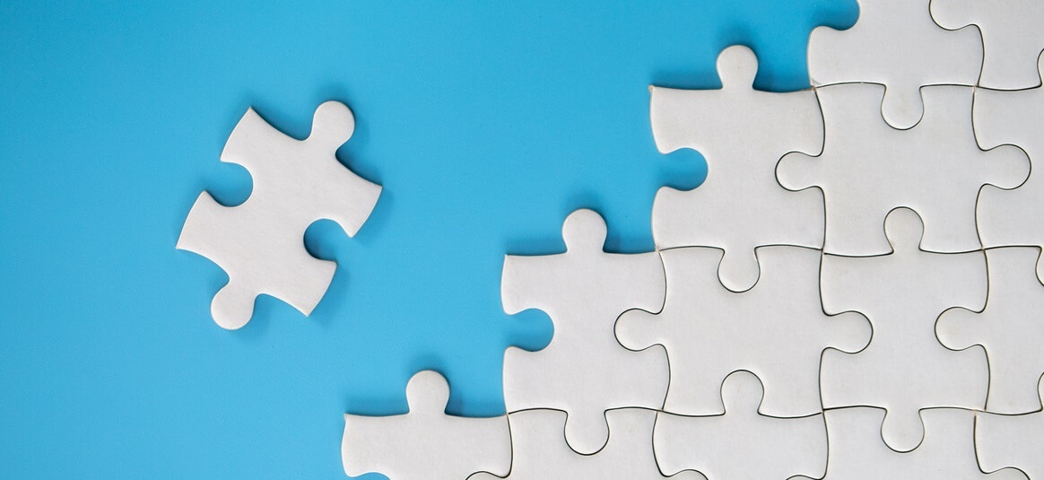 a white jigsaw on a blue background