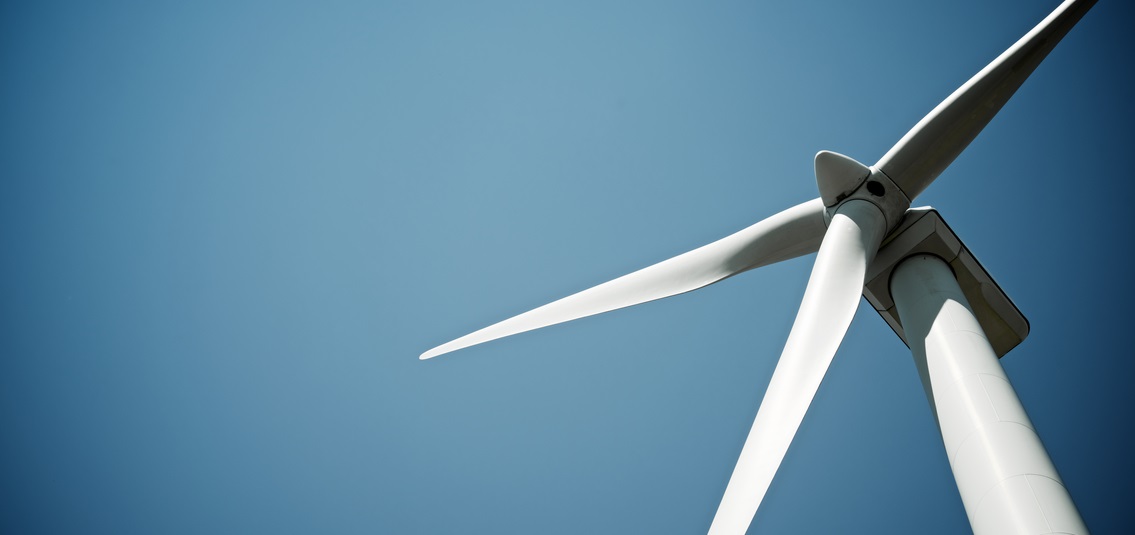 photo looking up at a wind turbine