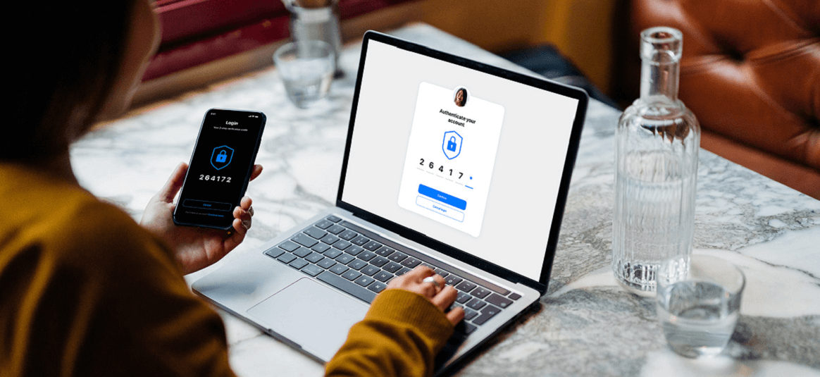 Woman logging into laptop with phone