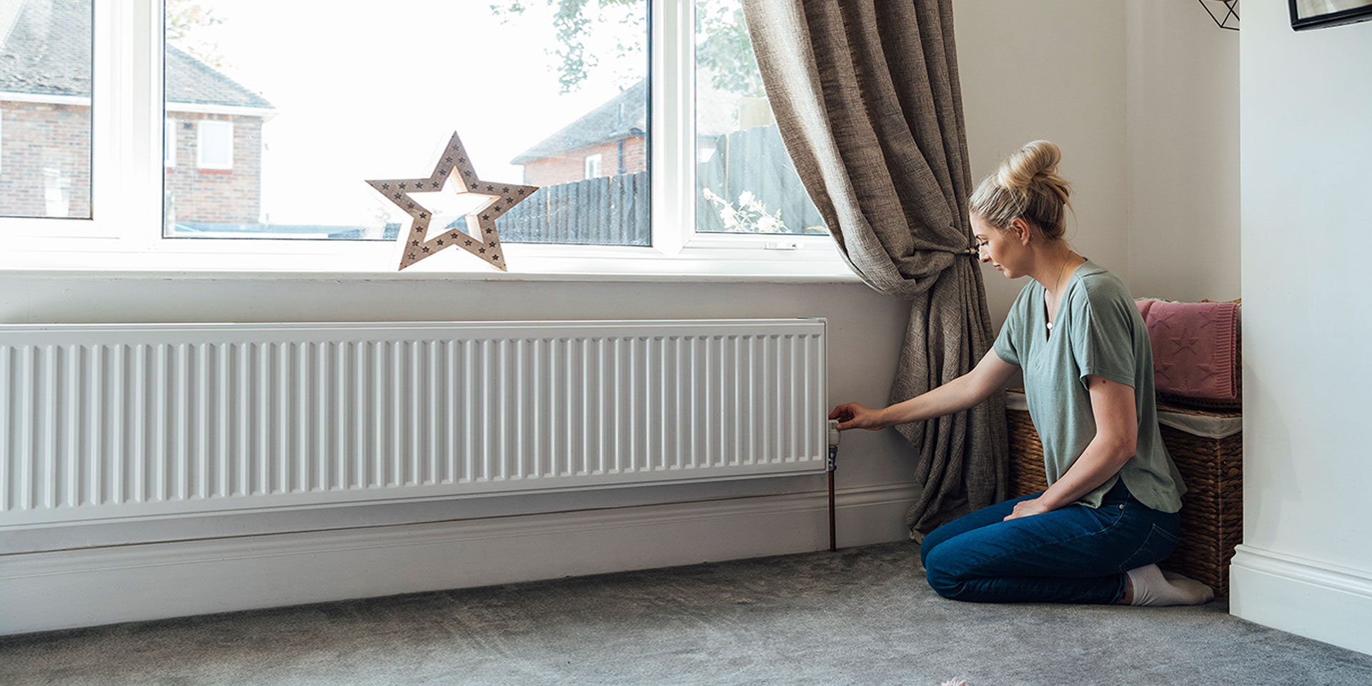 Woman checking radiator heat