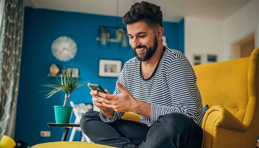 Man sitting on sofa with his phone