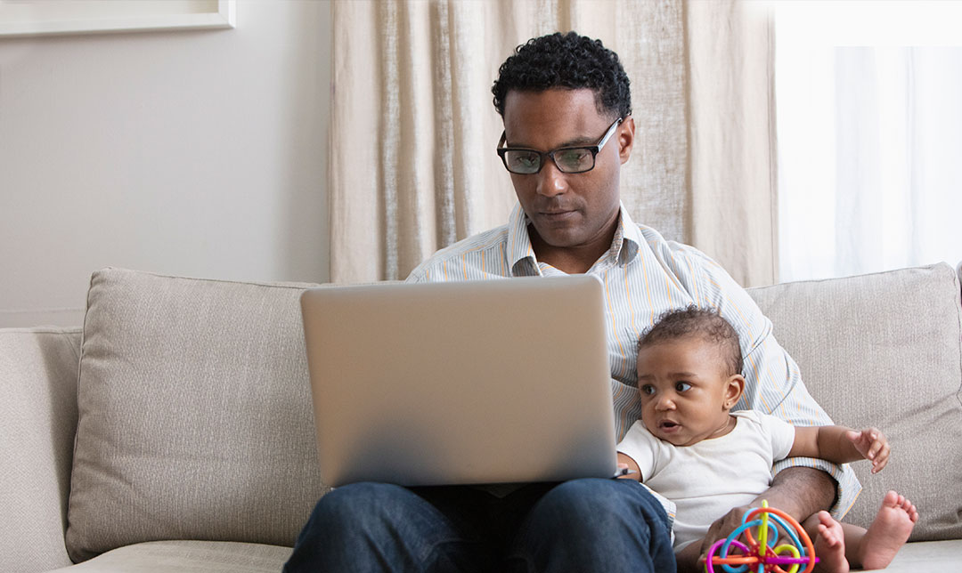 Couple sitting in front of laptop